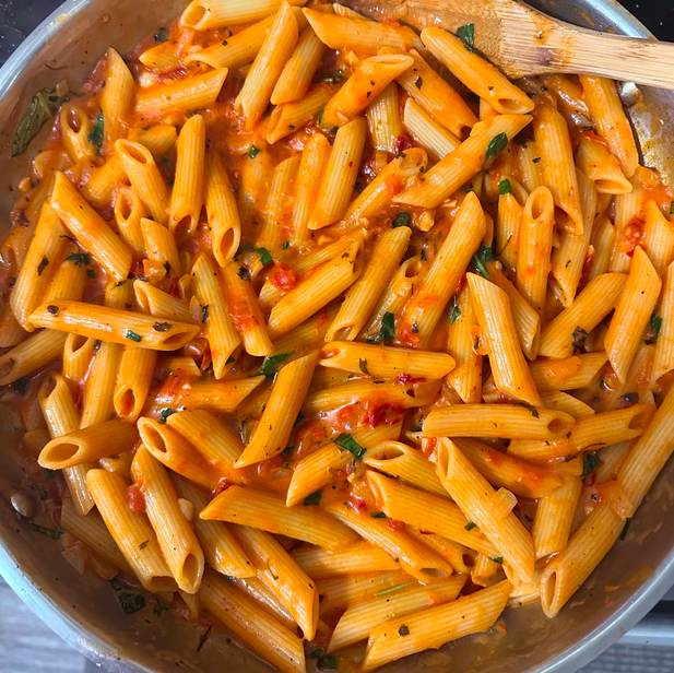 Creamy sun-dried tomato pasta with penne, basil and coconut milk sauce