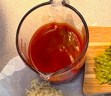 Homemade red enchilada sauce made with tomato sauce, chicken broth and spices