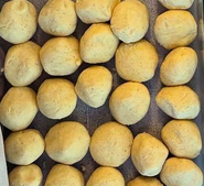Homemade flour tortilla dough divided into balls and resting before rolling